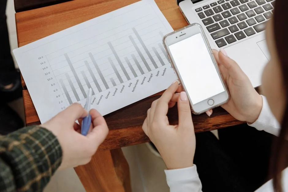 Top view of a desk with social media hashtag, keyboard, and analytics chart in modern design.